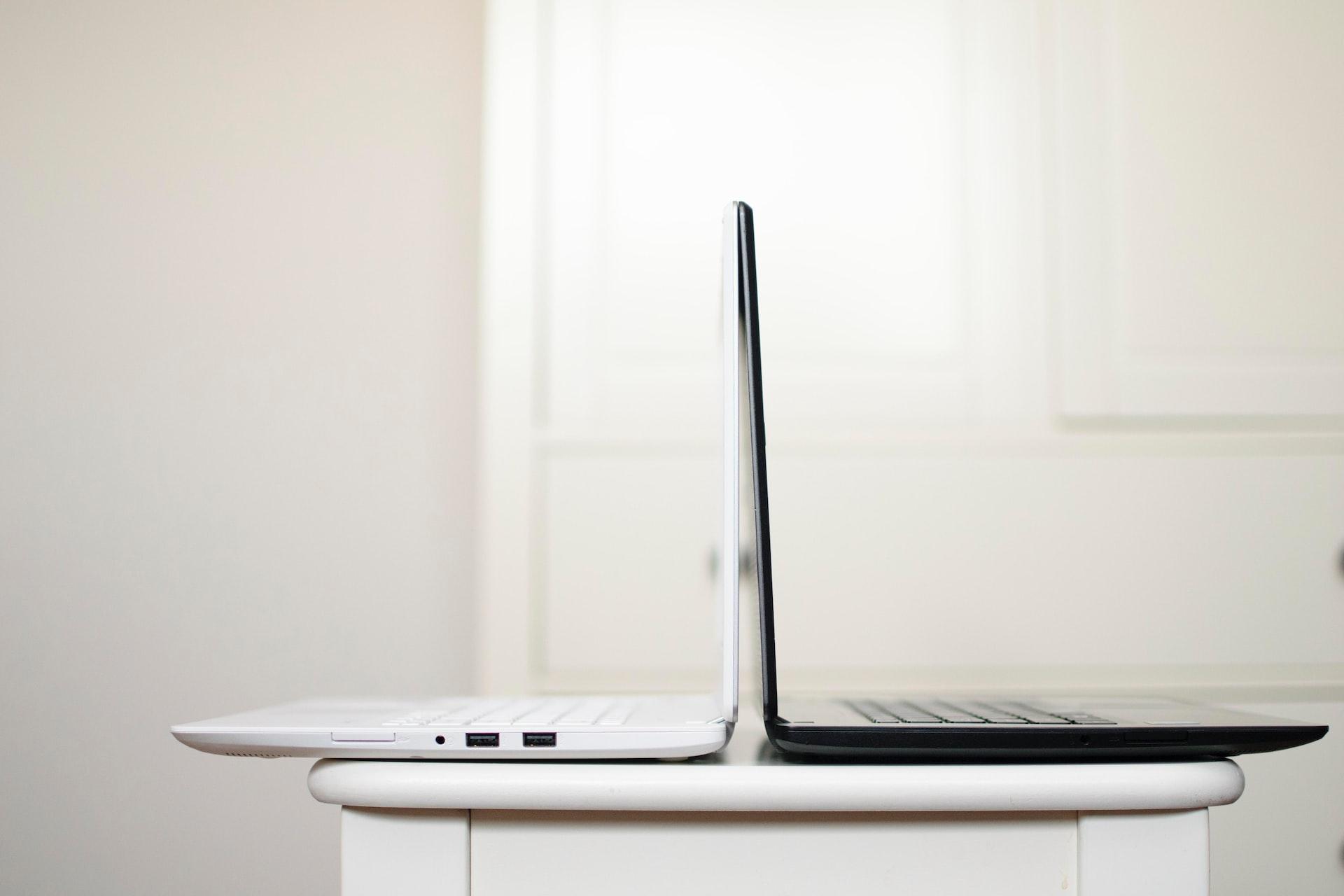 black and white laptop on table back to back